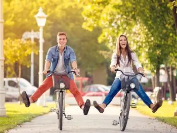 Happy couple riding bikes around anaheim neighborhoods